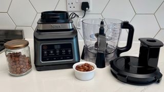 The Ninja 3-in-1 Food Processor with Auto-IQ BN800UK with hazelnurts waiting to be chopped in the appliance