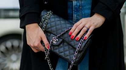 Maxilie Mlinarskij wearing a black Chanel bag and red nail polish on August 15, 2016 in Berlin, Germany