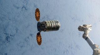 ISS' robotic arm reaches for cargo flight