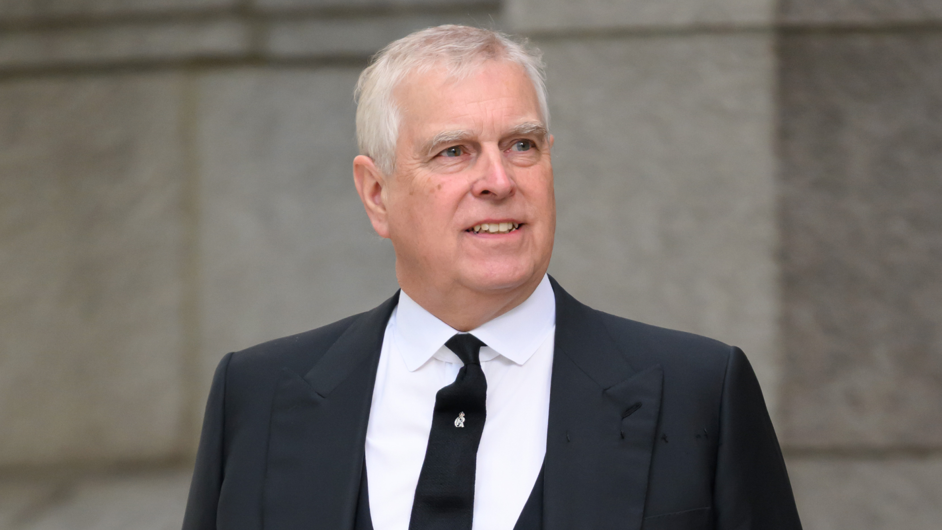 Ex-Prince Andrew wears a black suit with a white shirt and has gray hair