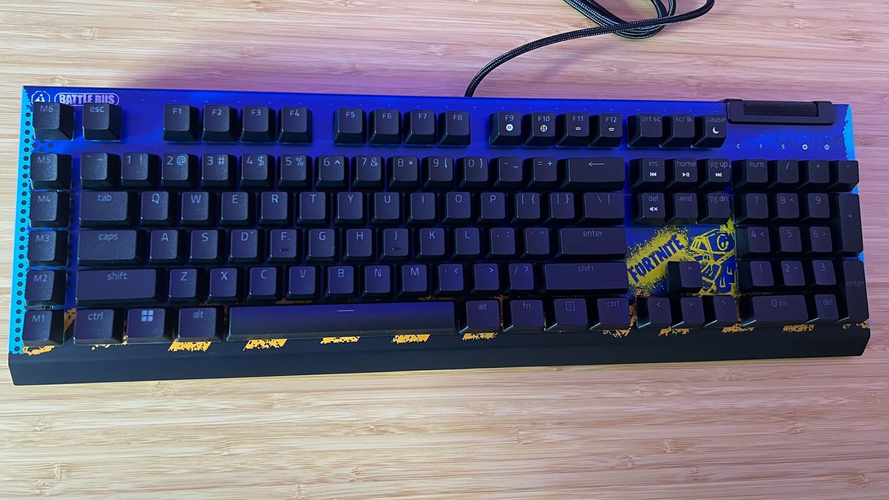 Razer BlackWidow V4 X Fortnite Edition gaming keyboard on a wooden desk