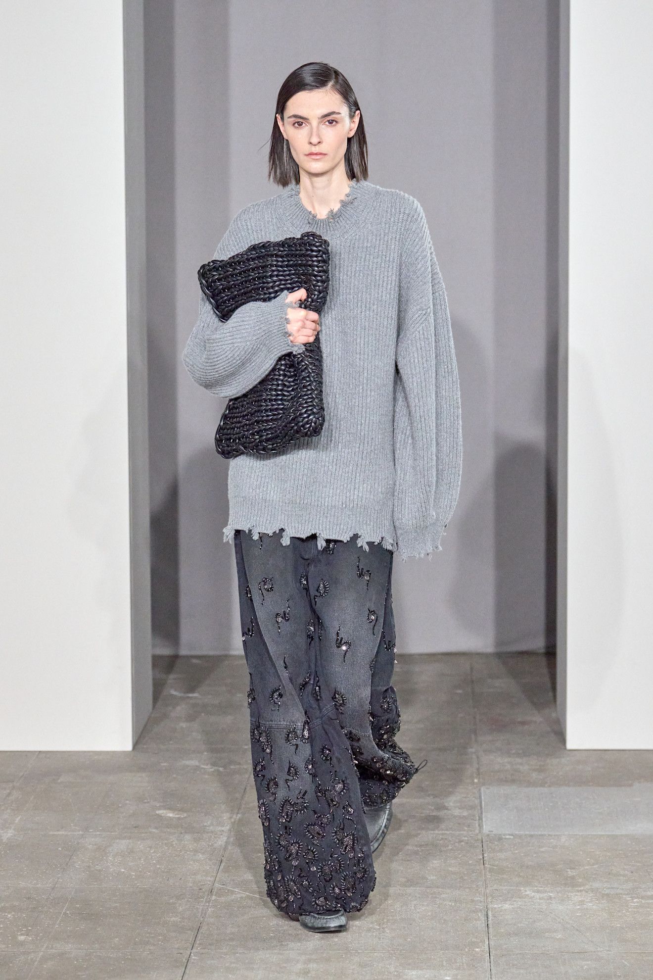Model on the runway wearing embellished jeans controversial denim trend.