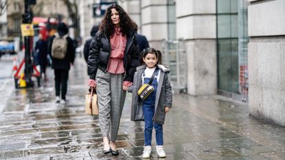 Mother and daughter walking down the street