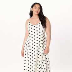 Woman wears black and white polka dot dress
