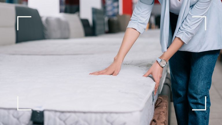 person testing mattresses in a store to demonstrate an article answering the question 'how often should you change your mattress'