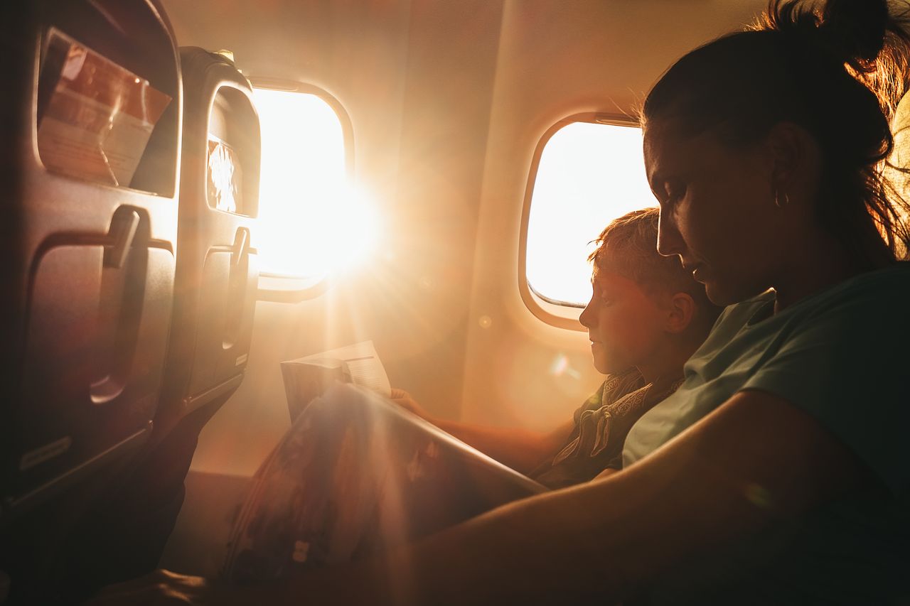 A mother and son on an airplane.