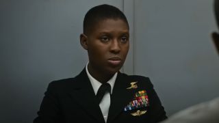 Jodie Turner-Smith sits in uniform, in a conference room, in Tom Clancy's Without Remorse.