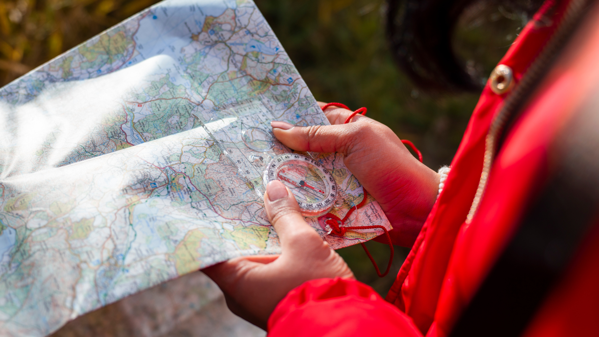 Woman using an OS map outside on a hike