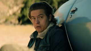 Agent Griff (Dylan Sprouse) sits behind his car in order to evade gunfire in Under Fire.