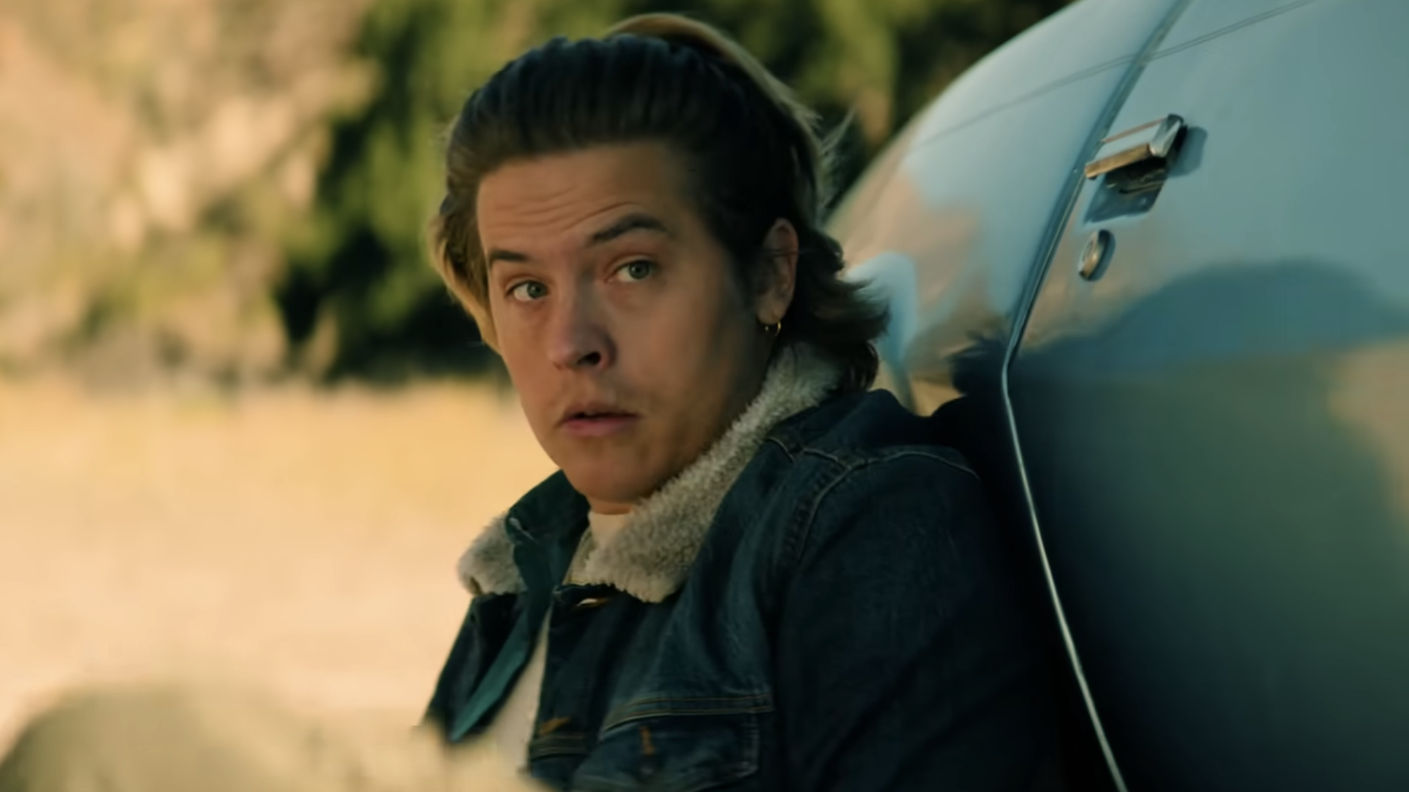 Agent Griff (Dylan Sprouse) sits behind his car in order to evade gunfire in Under Fire.