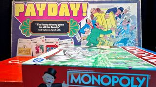 A collection of board games stacked together, with Paypay and Monopoly clearly visible