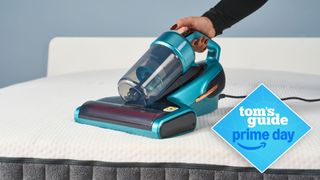 Blue Jimmy BX7 Pro mattress vacuum on white mattress surface with Tom's Guide Prime Day badge 