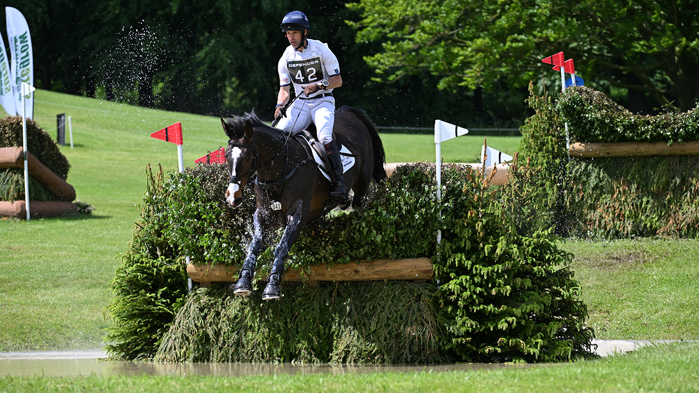 Bramham Horse Trials tickets Harry Meade and Annaghmore Valoner jump. brush fence in the water at Bramham 2024.