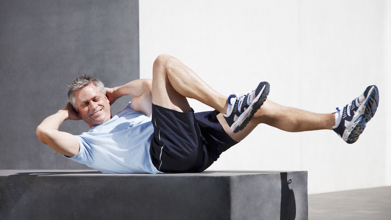 Man doing sit ups outdoors