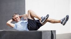 Man doing sit ups outdoors