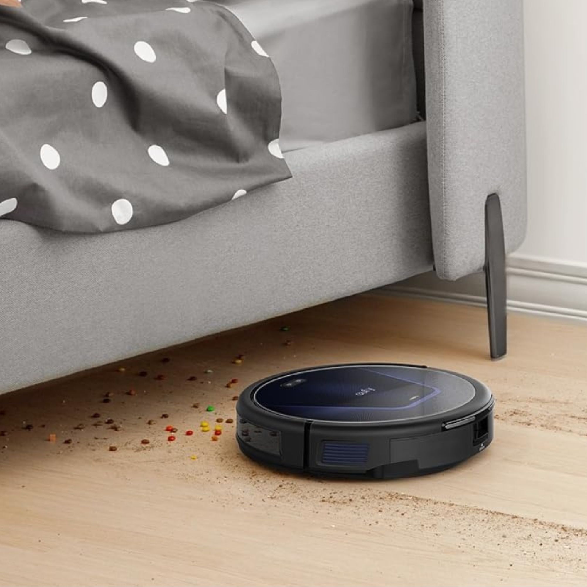 Eufy G50 robot vacuum cleaning up crumbs on wooden floor