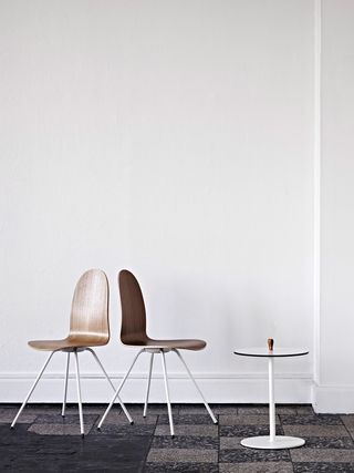 Image of two classic wooden tongue chairs and a small table