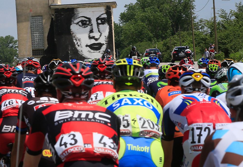 Street art hovers above the riders during stage 12
