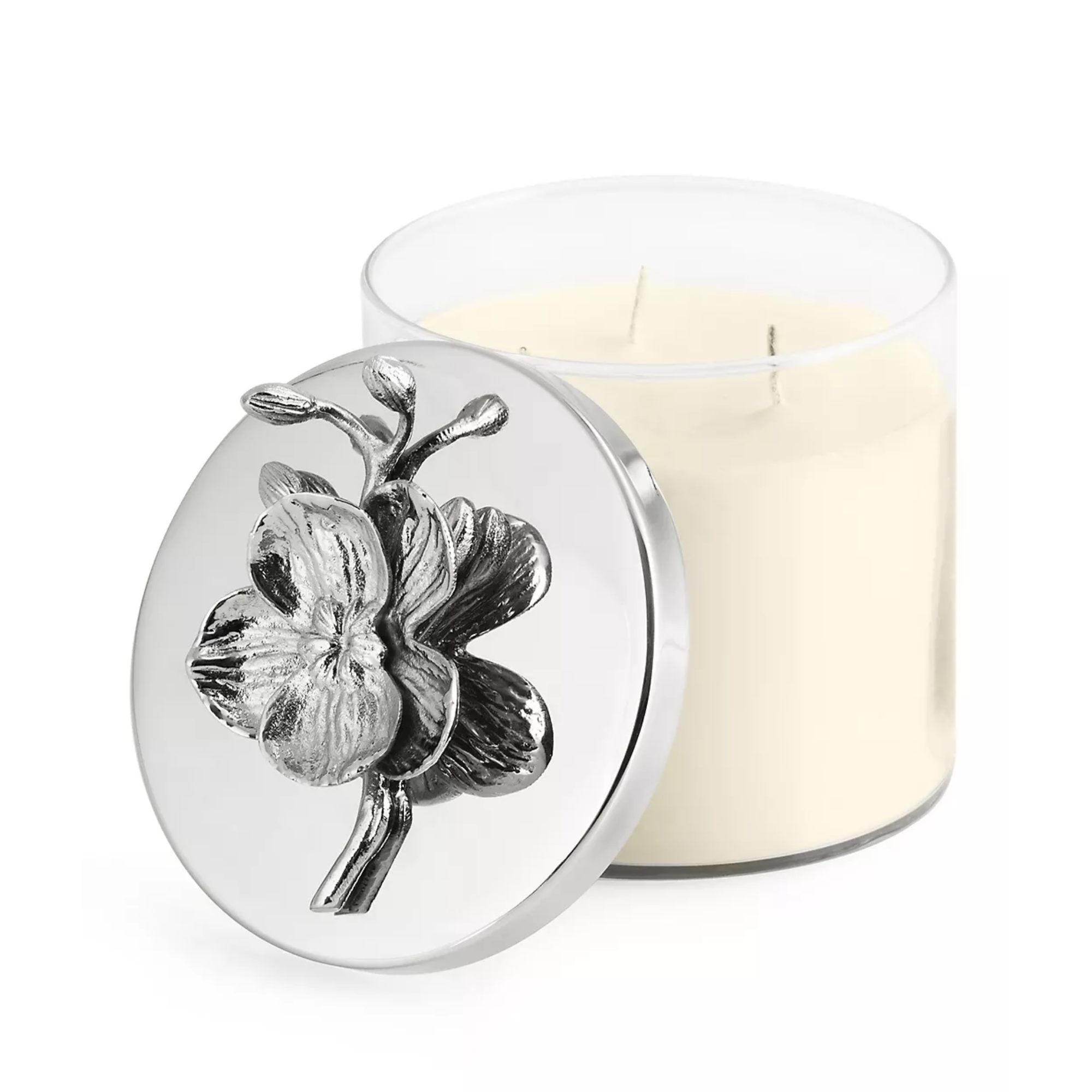 glass candle with a silver lid with a flower on top