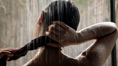 Woman washing her body under the shower