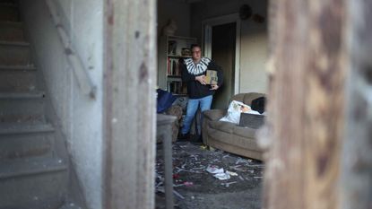 Photo of Missy Hendrickson salvaging items from her apartment after it was destroyed by a tornado late Friday evening on December 12, 2021 in Mayfield, Kentucky.