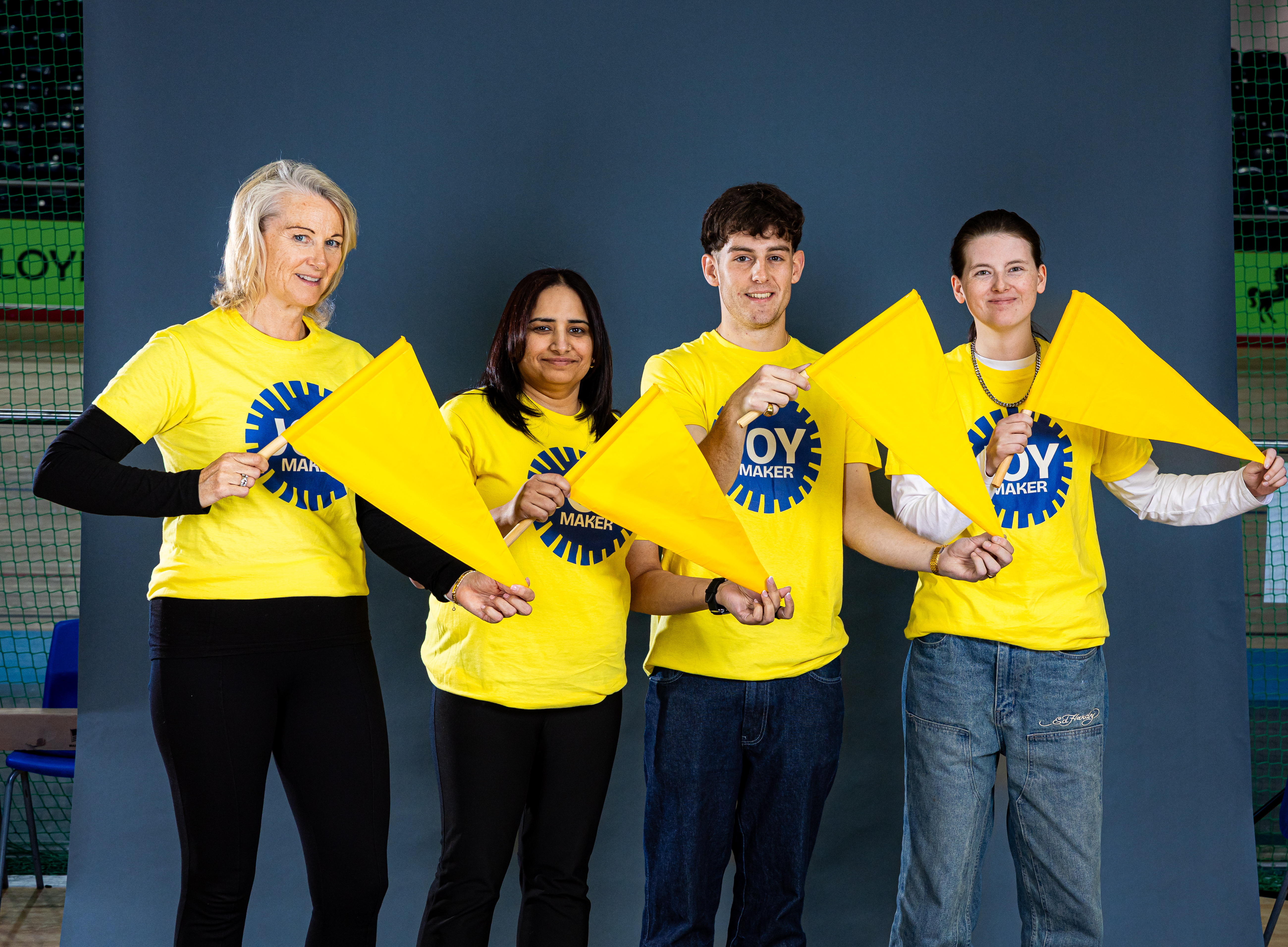 JOY Makers in yellow t-shirts holding flags