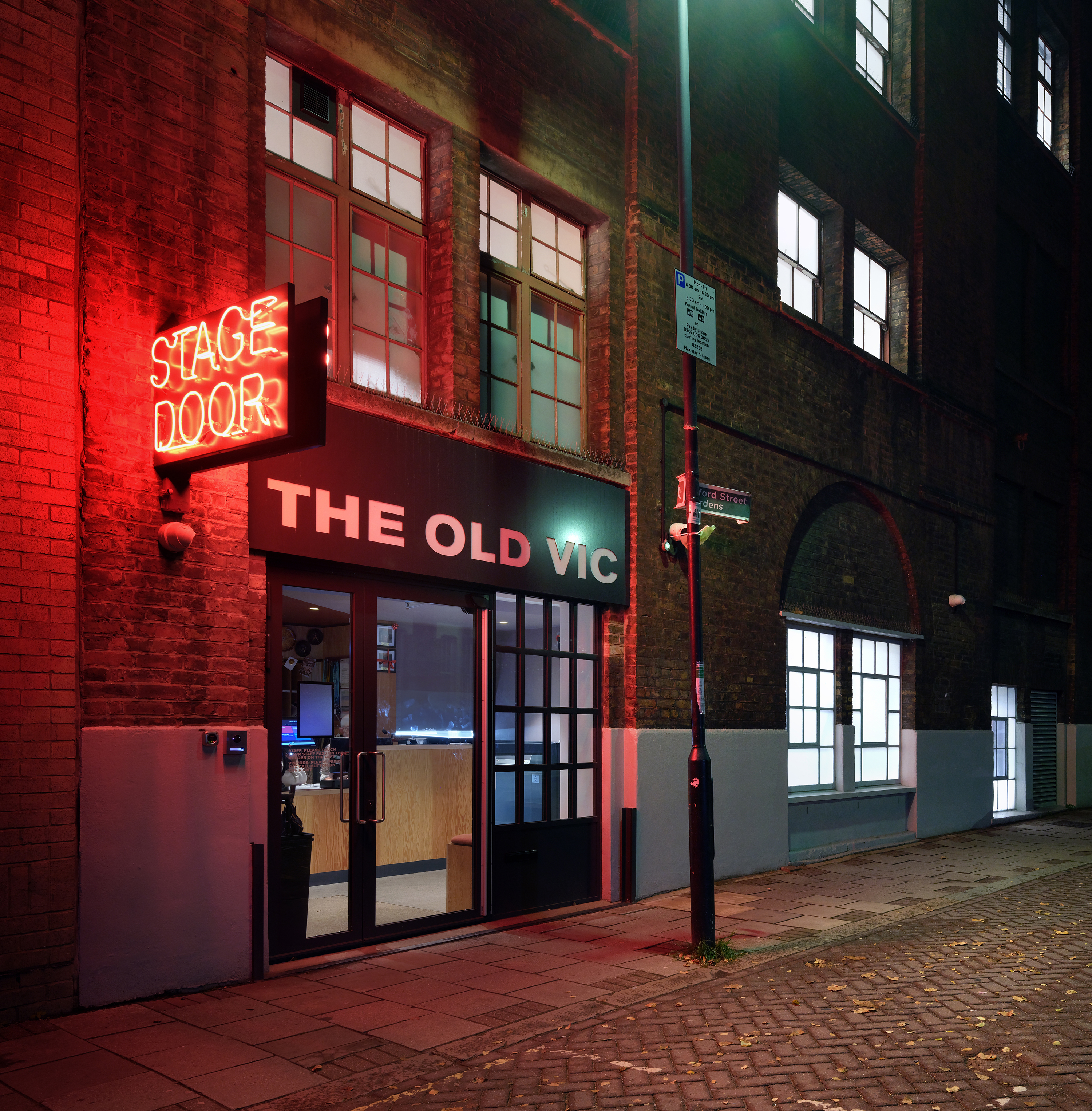 Backstage at the Old Vic, colourful spaces in warm terracota colours in a timber framed building
