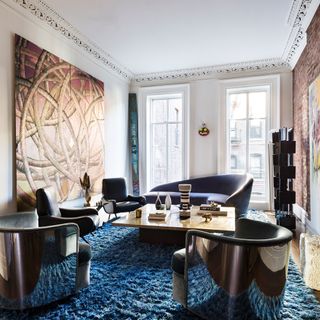 this artistic space is dressed to perfection with a texture cobalt blue rug