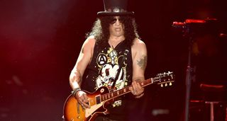 Slash with top hat and Les Paul, onstage at Coachella in 2016