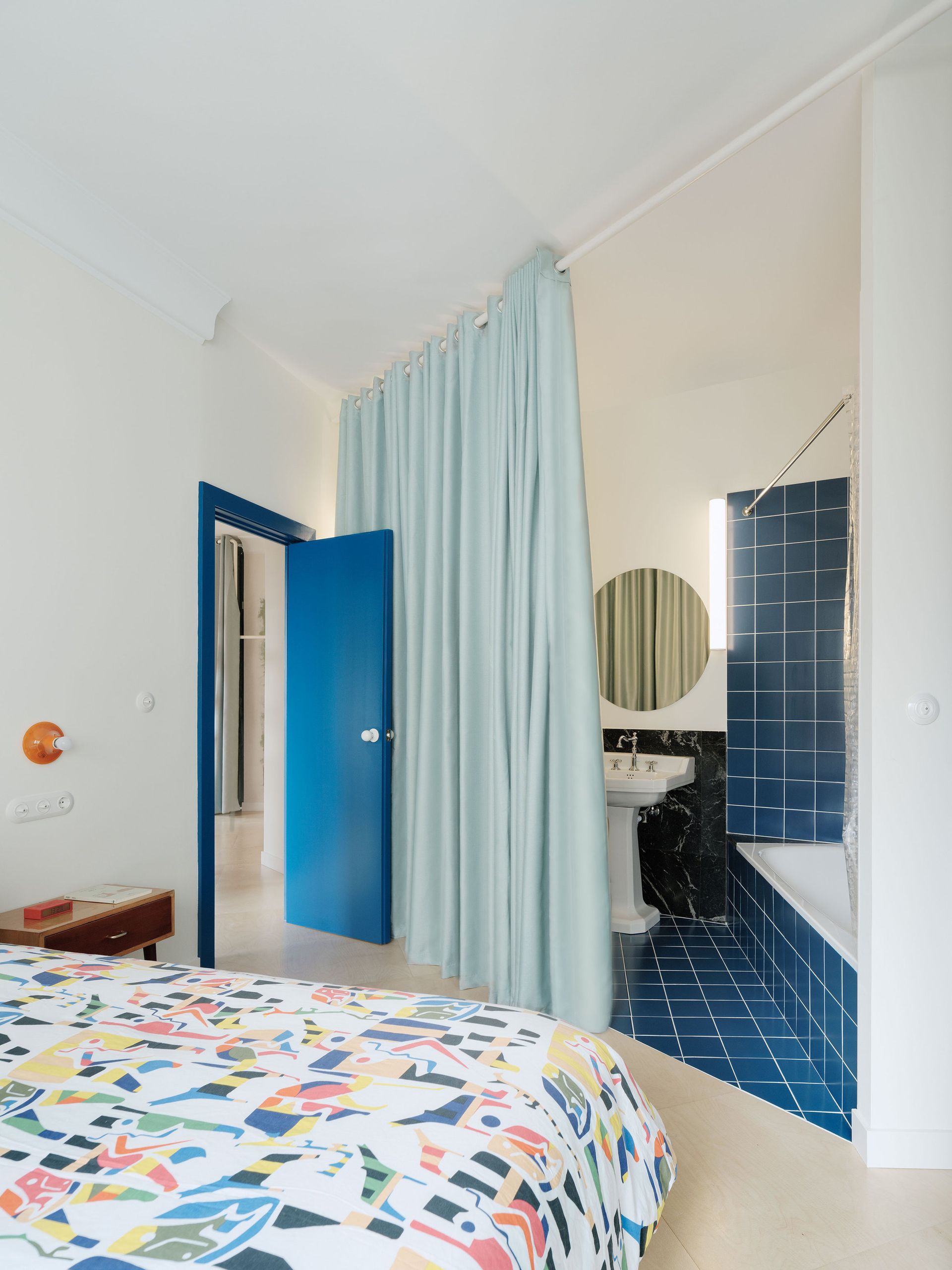 A bedroom with curtains dividing the room