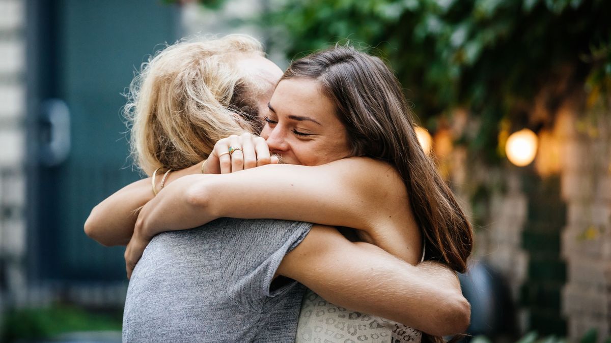 young couple embracing at a barbecue with friends