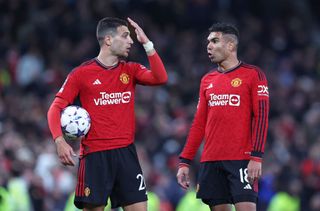 Diogo Dalot and Casemiro of Manchester United talk during the UEFA Champions League match between Manchester United and Galatasaray A.S at Old Trafford on October 03, 2023 in Manchester, England. (Photo by Alex Livesey/Getty Images)