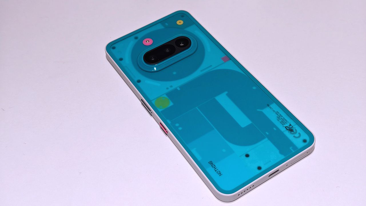 Nothing 3a Community Edition, a green phone on a white table