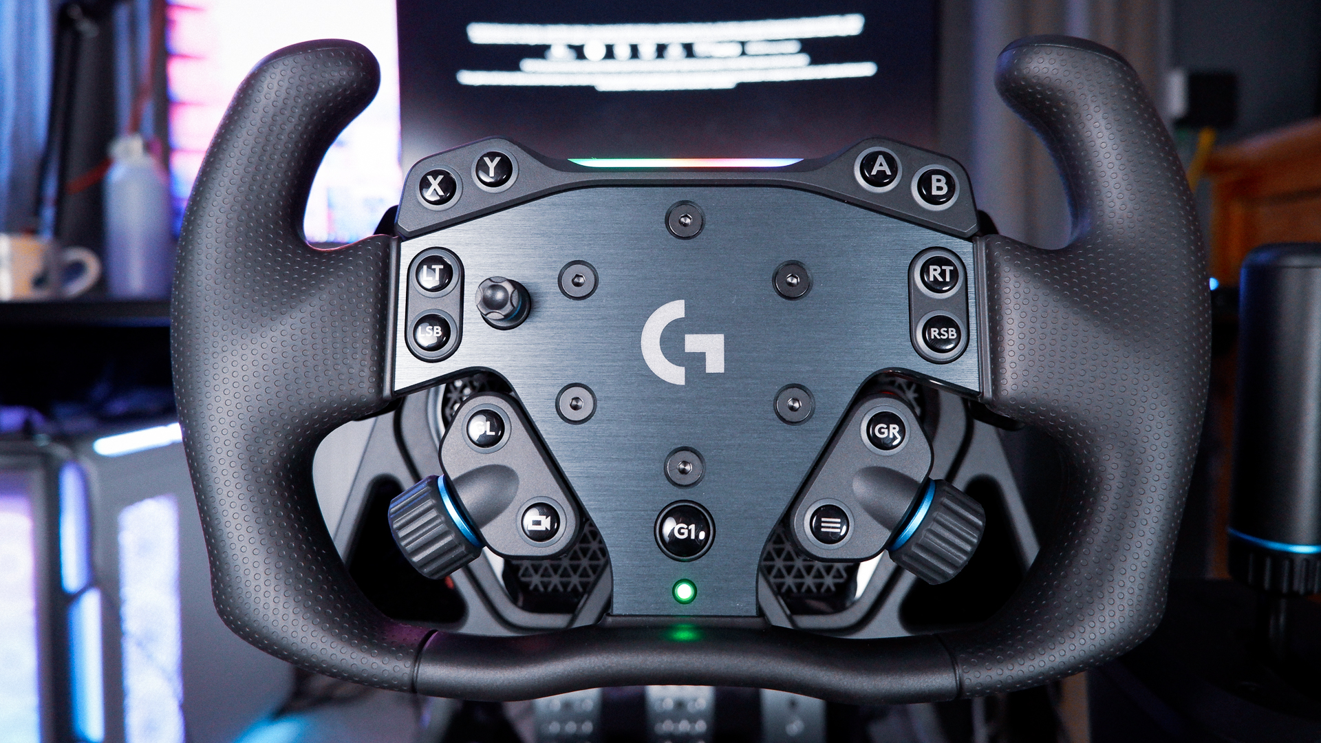 The Logitech G RS Wheel Hub and RS Track Wheel on a desk and installed on a sim racing wheel base.