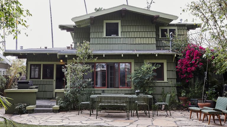 exterior of green Craftsman house