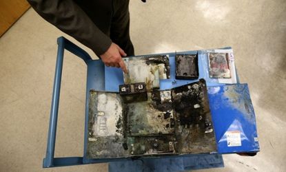 The charred box from a Japan Airlines 787 in which the battery caught fire, is displayed.