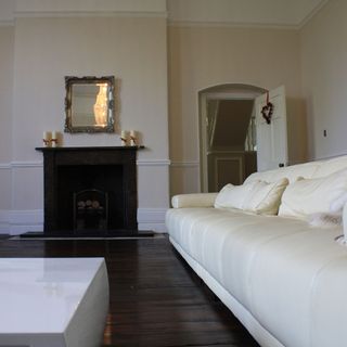 white living room with sofa and fire place