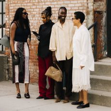 four women at new york fashion week wearing fall trends