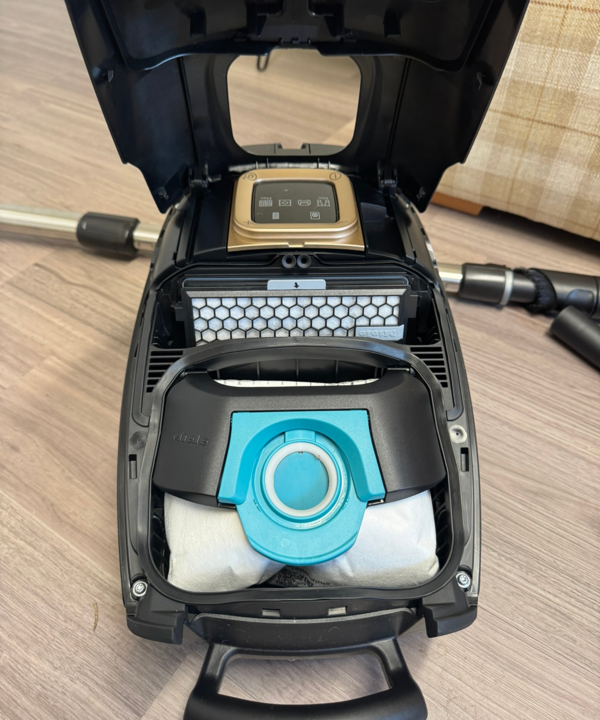 Inside the Miele Guard L1 Cat and Dog canister vacuum, showing vacuum bag and air filter.