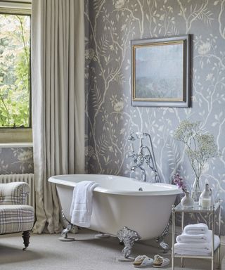 Bathroom curtain ideas with taupe linen curtains with blue and cream patterned wallpaper and claw foot bathtub