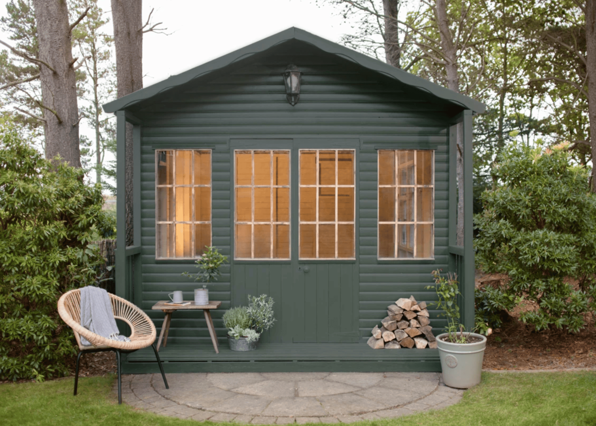 garden shed with four panelled windows, painted in forest green