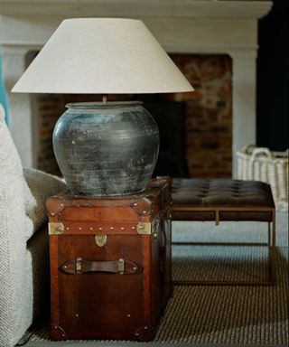 Vintage lamp displayed on a vintage trunk in a living room