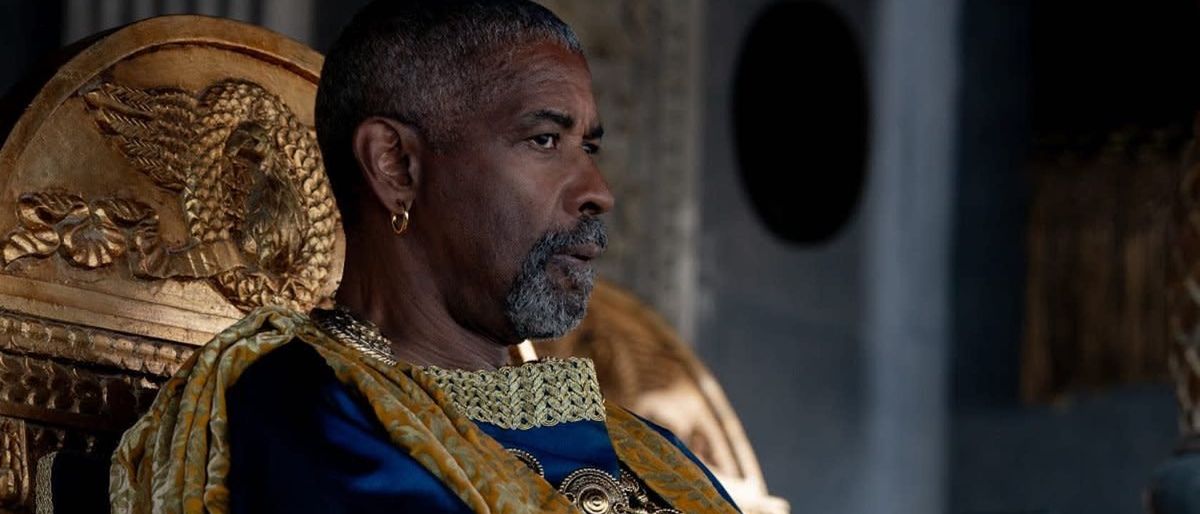 Denzel Washington sitting in gold throne in Gladiator II