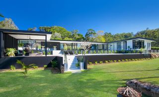 The frame of the home is built of steel and timber, with either glass or solid cladding painted black and white in between