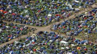 The trick to capturing people or big crowds is to shoot from above an free space sideways – not straight down – using a longer lens. A Mavic 2 Zoom might help for images like this of Glastonbury Festival