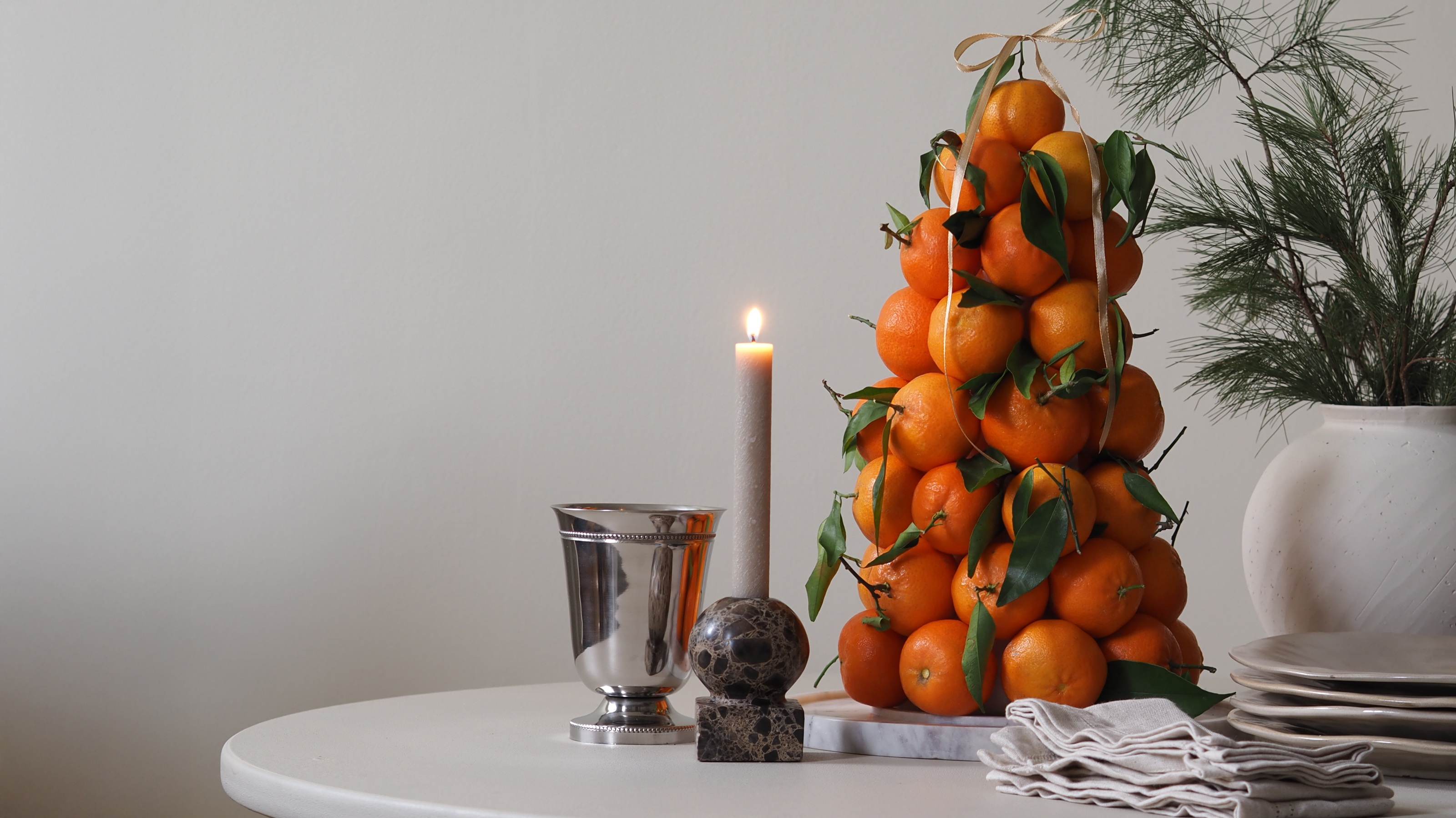 an orange tree centerpiece on a table