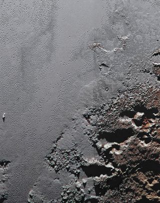 A close-up view of the boundary between the icy plain of Sputnik Planum and the rugged highlands known as Krun Macula, on the surface of the dwarf planet Pluto.