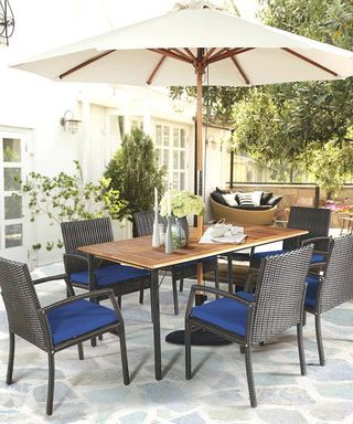 patio with stone rustic patio tiles and a traditional dining set with a parasol