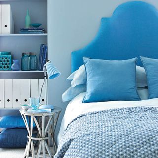 blue bedroom with blue wall and blue bed and couch