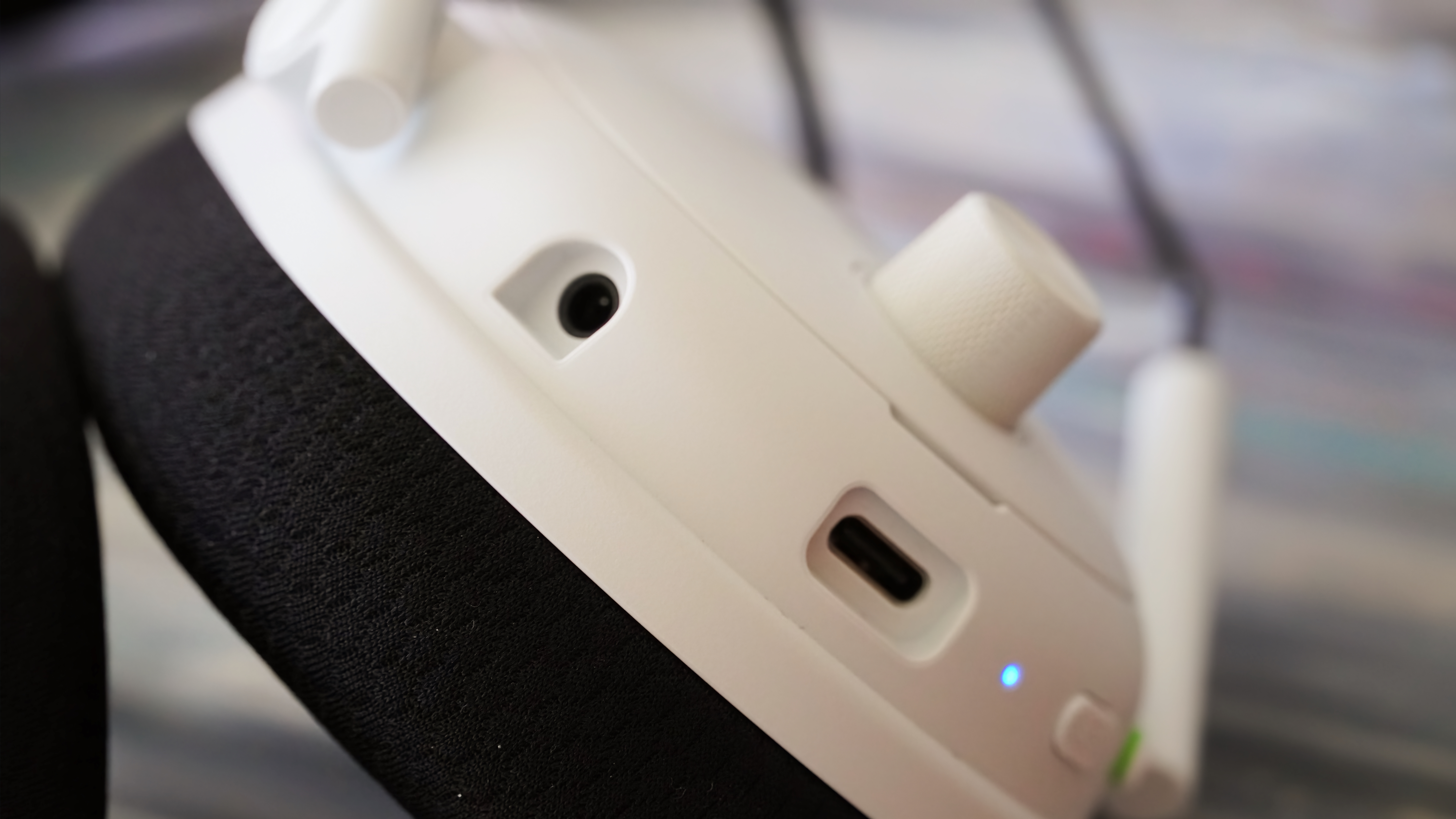 The Razer BlackShark V3 Pro gaming headset laid atop records showing the USB-C and 3.5mm ports.